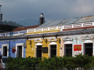 Colorful buildings - La Antigua, Guatemala Colorful buildings along a street in La Antigua, Guatemala, Agua volcano in background