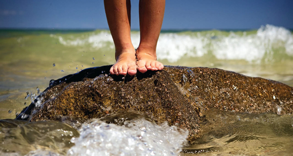 Feet on Grand Traverse Bay beach rock - Traverse City, Michigan USA Feet on Grand Traverse Bay beach rock in Traverse City, Michigan USAFeet on beach rock in Traverse City, Michigan USA